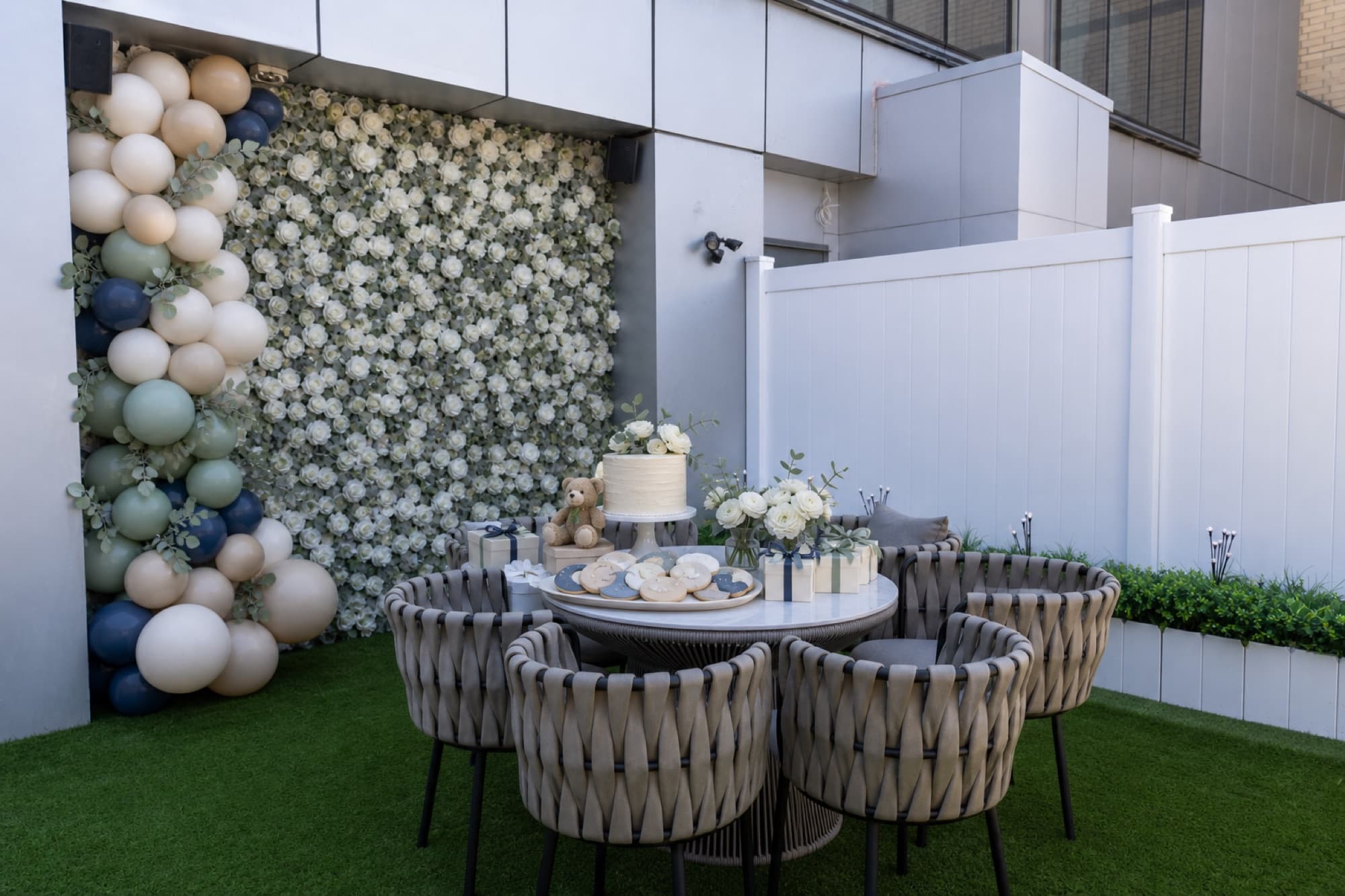 Flower wall and balloon garland set for a baby shower on the terrace