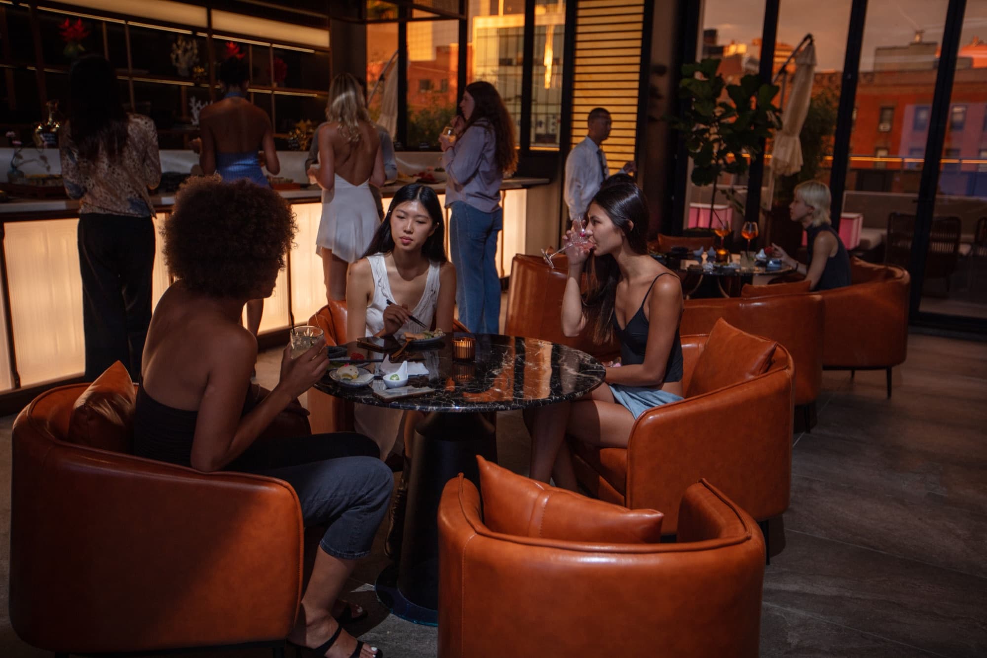 Lounge armchairs and small plates by the terrace windows