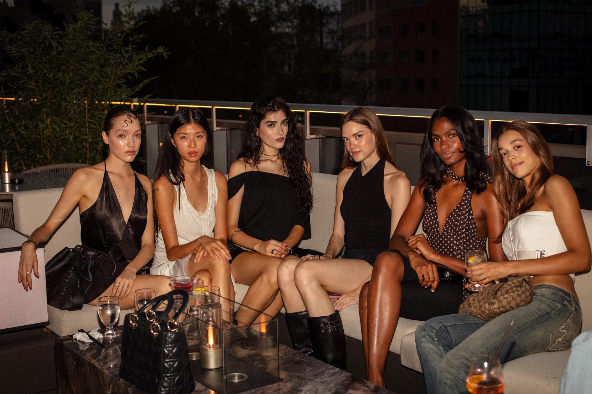Friends together on the terrace banquette after sunset