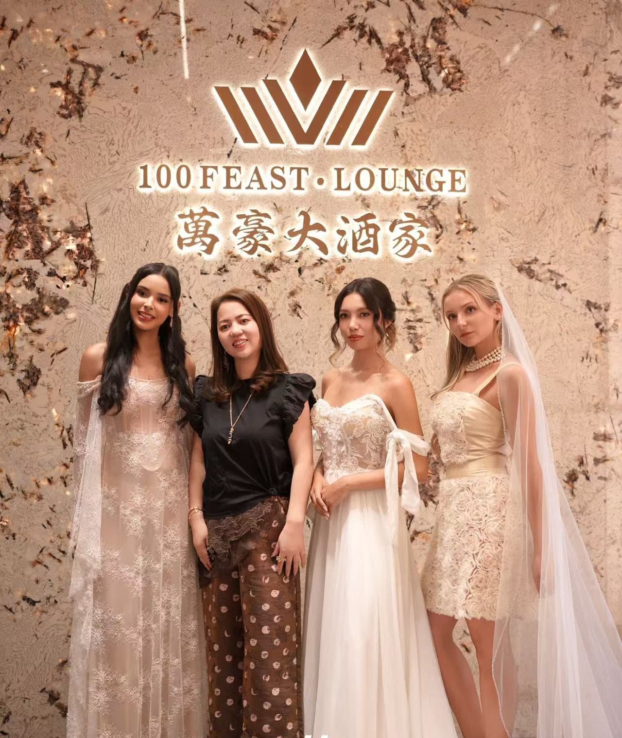 Models and the designer at the 100 Feast & Lounge wall