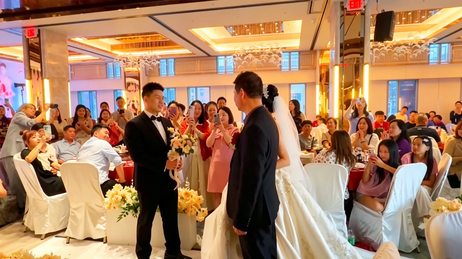 The couple in the aisle among their guests