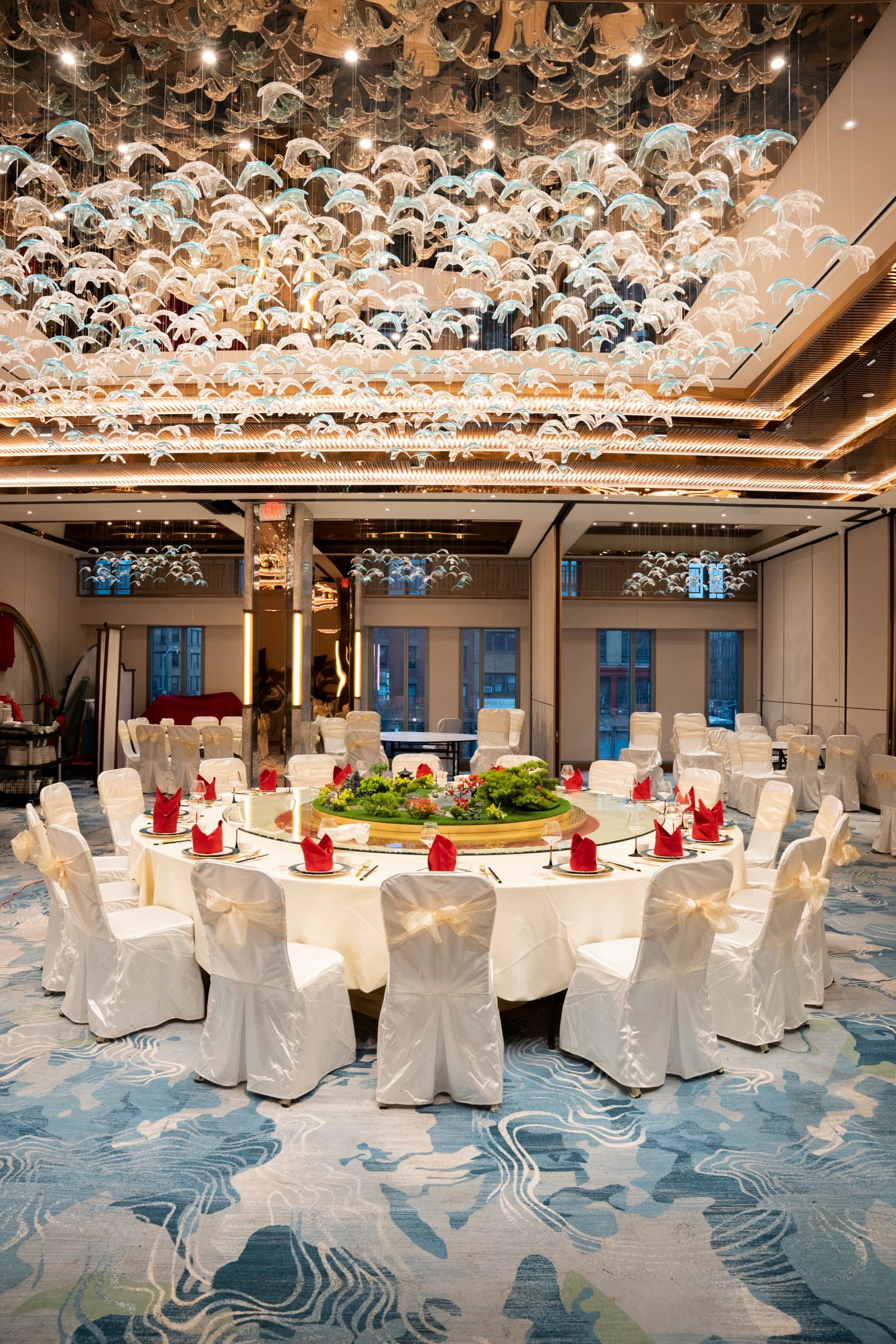 VIP banquet table beneath the dolphin-wave chandelier