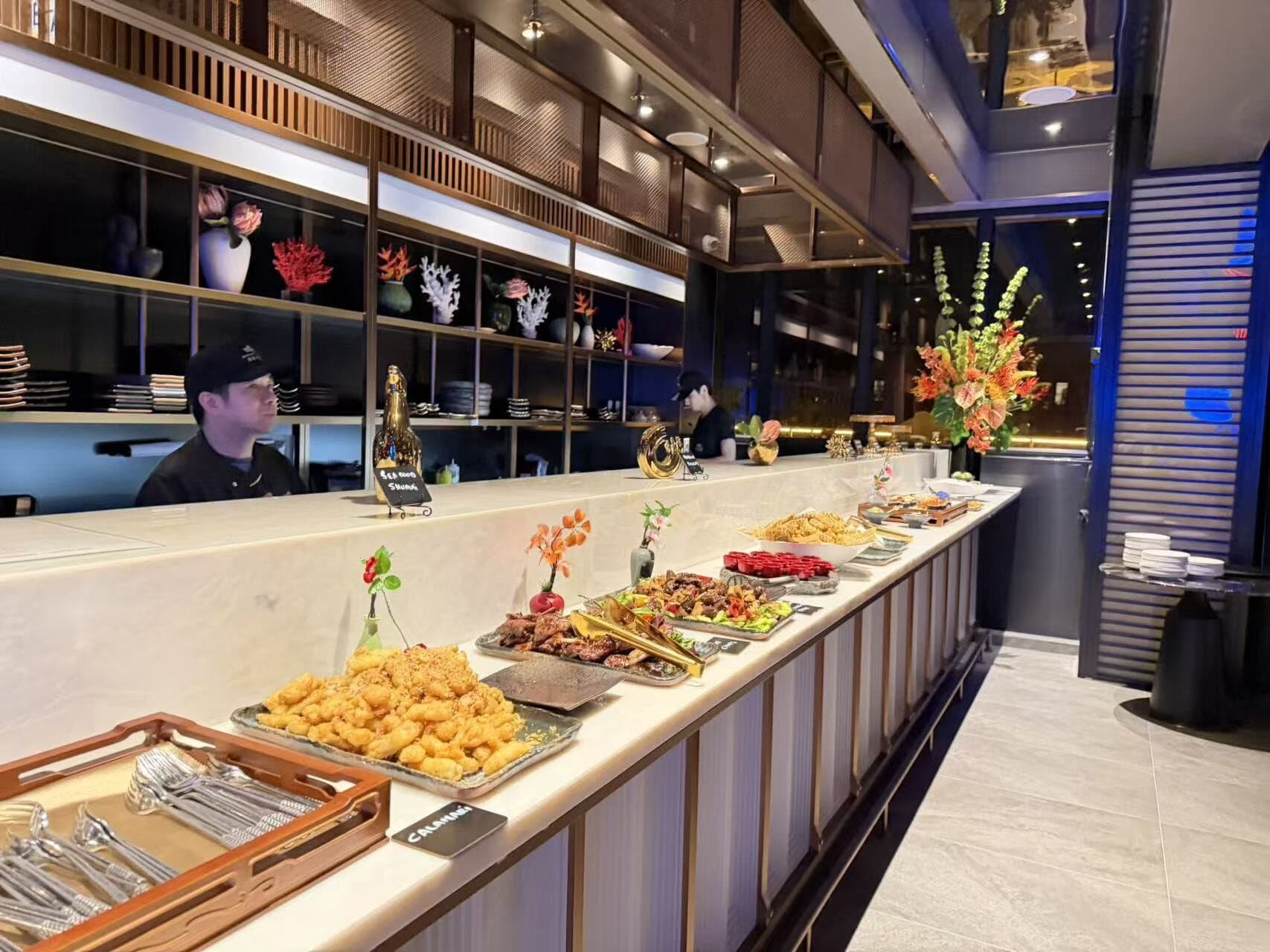 Marble buffet counter set with hot dishes and live-station service