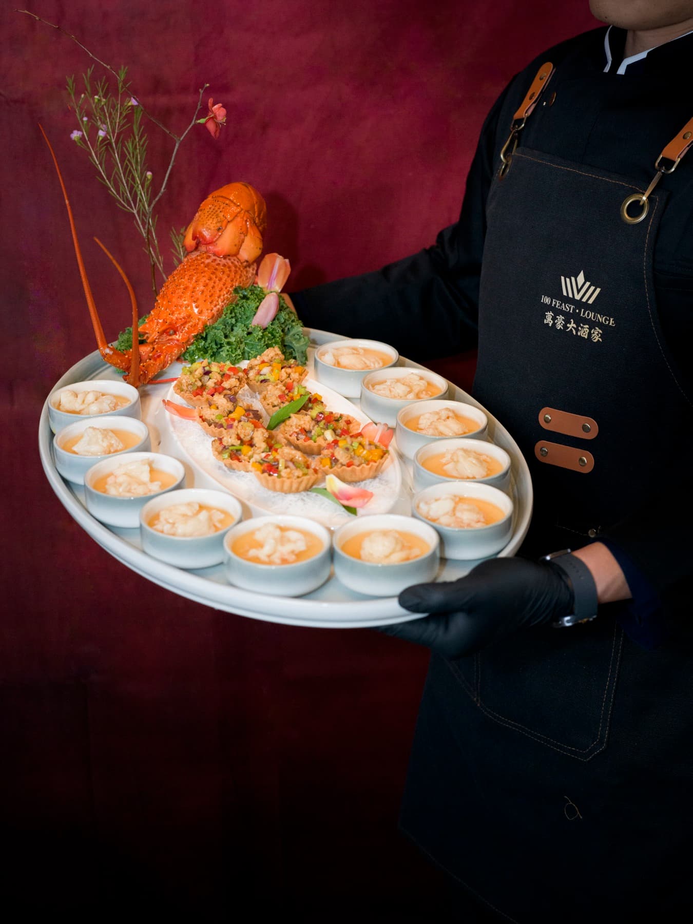 Server carrying a grand lobster platter